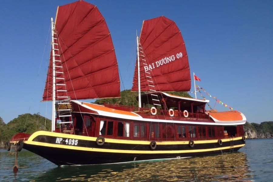 Experience a Lan Ha Bay private boat tour on a beautiful traditional wooden cruise with red sails