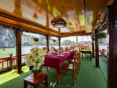 Open-air dining deck with stunning karst mountain views during a Lan Ha Bay private cruise